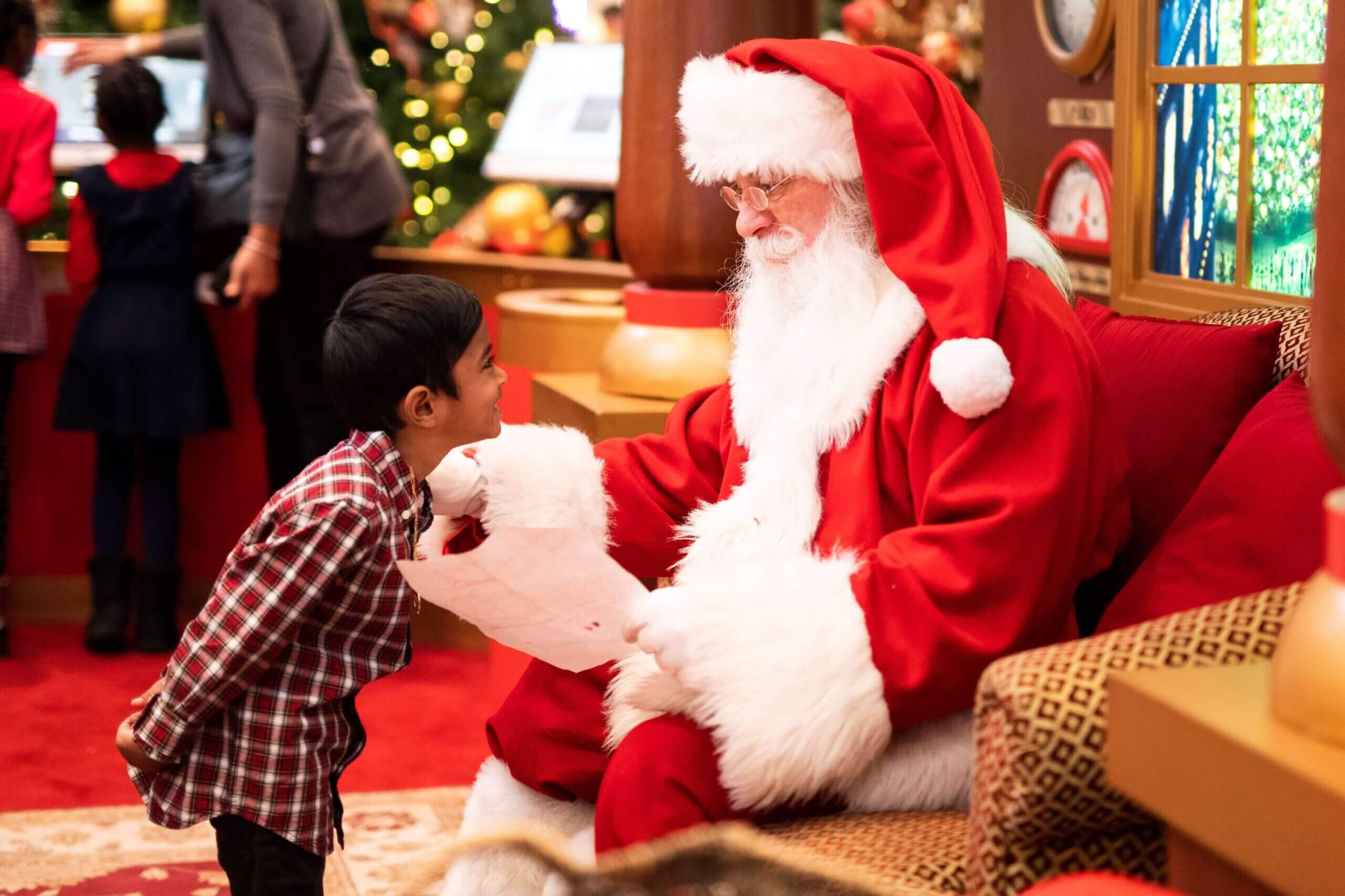Young Boy Smiling at Seated Santa
